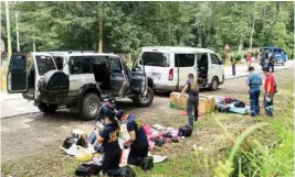  ?? AP/PTI ?? Police inspect the contents of the vehicles, in which the mayor and his nine bodyguards were travelling, following a shootout at Makilala township, North Cotabato province in southern Philippine­s on Friday