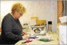  ??  ?? Sherri Tunis works on her stained glass art project during an introducto­ry class for adults at Art Fusion 19464 in Pottstown.