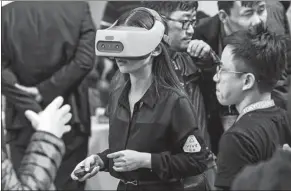  ?? PROVIDED TO CHINA DAILY ?? A visitor checks out a Vive Focus at a developer conference held in Beijing. Users can enjoy the device without attaching it to personal computers or smart phones.