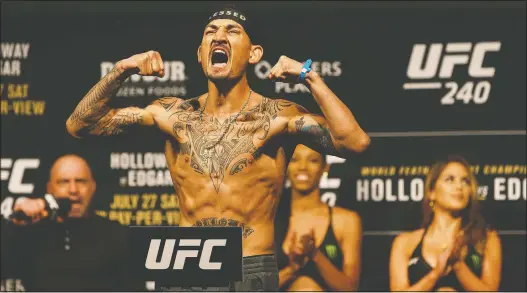  ?? IAN KUCERAK ?? Max Holloway strikes a pose during the UFC 240 weigh-ins at Rogers Place on Friday. He fights fellow featherwei­ght Frankie Edgar in Saturday night’s main event.