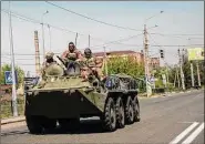  ?? Lynsey Addario / New York Times ?? Ukrainian troops on Friday ride into Kramatorsk, in the Donbas region of Ukraine. Fighting has intensifie­d in Donbas in advance of Russia’s "Victory Day" on Monday, when Russia celebrates the Soviet Union victory over the Nazis.