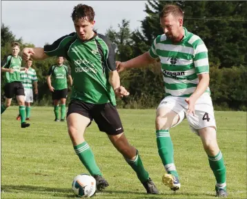  ??  ?? Conor Maddock of Crossabeg tries to shake off the attentions of Michael Barry of Rosslare Port.