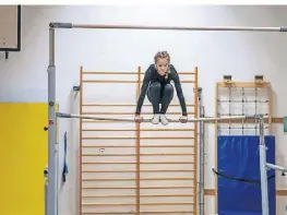  ?? FOTO: NADINE BOHLAND/DPA ?? Karla Thies turnt beim Training am Stufenbarr­en. Der höhere Holm ist zweieinhal­b Meter hoch.