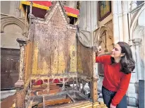  ?? ?? Conservato­r Krista Blessley works on the chair, which is covered in carved graffiti from Westminste­r schoolboys