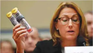  ??  ?? WASHINGTON: In this Wednesday, Sept 21, 2016, file photo, Mylan CEO Heather Bresch holds up EpiPens while testifying on Capitol Hill, before the House Oversight Committee hearing on EpiPen price increases. —AP