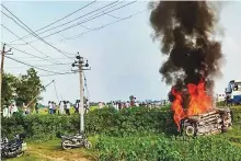  ?? PTI ?? A vehicle set ablaze after agitating farmers were run over by vehicles in Lakhimpur Kheri, Uttar Pradesh, yesterday.