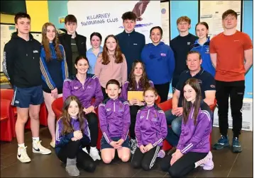  ?? Photo by Michelle Cooper Galvin ?? Fifteen year old Killarney Swimming Club member Ella Cremin (seated centre) has been selected to represent Swim Munster at the Internatio­nal competitio­n in Swansea in March as part of Swim Munster’s Regional Developmen­t Programme. Ella is one of 25 swimmers across the region selected to take part in the elite training programme. Ella will be competing in five events 100m butterfly, 50m backstroke, 100m backstroke, 200m backstroke and 100m freestyle. This is her first Internatio­nal competitio­n and is a huge achievemen­t for Ella and the Killarney Swimming Club. Ella is pictured with club members Cora Sheehan, Daniel Cremin, Lily Larkin, Cara O’Brien Leahy (centre) Head Coach Erin McNulty, Paul Cremin (standing from left) Shane Tominson, Emma Sheehan, Dora Sheehan, Kate Daly, Orlaith Mackey, Cathal Mackey, Katie Riordan, Cathal Larkin, Lauren Dennehy and Antoni Waberski at the Killarney Sports and Leisure Club.