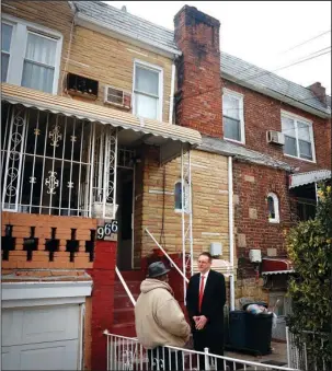  ?? The Associated Press ?? SCAMMED: Raymond Murray gets a visit from his lawyer, Robert Seewald, right, on Feb. 1 at his home in New York. Murray’s lawyers are still fighting in court for the return of the title to his home. Meantime, he worries his neighbors will learn he was...