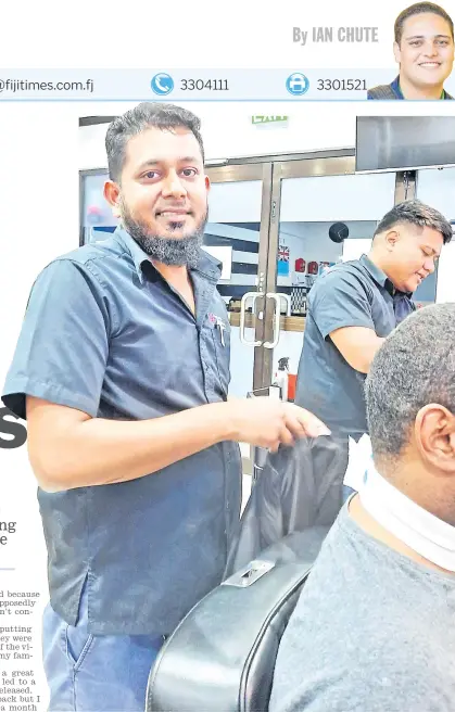  ?? Picture: IAN CHUTE ?? Mohammed Imroz prepares a customer for his hair cut at his barber shop in Samabula.