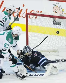  ?? JOHN WOODS/THE CANADIAN PRESS ?? Alexander Radulov (47) of the Dallas Stars scores on Winnipeg Jets goaltender Connor Hellebuyck during first-period action in Winnipeg on Thursday.