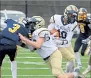  ?? JULIA MALAKIE / SENTINEL & ENTERPRISE FILE ?? St. Bernard’s Damien Jones carries the ball during last week’s game against Littleton.