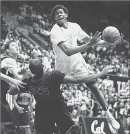  ?? SUSAN TRIPP POLLARD/ STAFF ?? Tyrone Wallace commits an offensive foul as he runs over USC’s D. J. Haley ( 33).