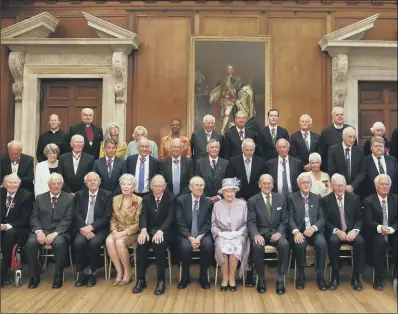  ??  ?? GOOD COMPANY: The Queen and the Duke of Edinburgh pose with some of the Companions of Honour after the anniversar­y reception.