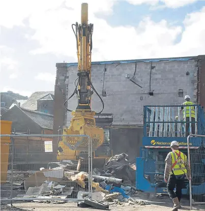  ?? Pictures: Angus Findlay. ?? Builders moved onto the site and began demolition of the old workshops and rehearsal rooms at the back of the theatre to make room for the extension.