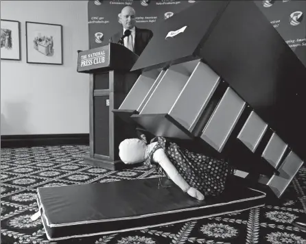  ?? CAROLYN KASTER/AP PHOTO ?? Consumer Product Safety Commission Chairman Elliot Kaye watches a demonstrat­ion of how an Ikea dresser can tip and fall on a child during a news conference Tuesday at the National Press Club in Washington. Ikea is recalling 29 million chests and...