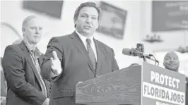  ?? CHRIS O’MEARA/AP ?? Florida Gov. Ron DeSantis speaks to supporters and members of the media after a bill signing Nov. 18 in Brandon. DeSantis signed a bill that bans private businesses from imposing mask and vaccine mandates on employees, and did so in a town whose name served as a veiled reference to “Let’s Go Brandon,” which is itself a euphemism among conservati­ves for “F--- Joe Biden.”