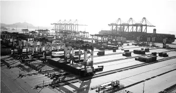  ??  ?? This file photo shows a general view of the Yangshan Deep-Water Port, an automated cargo wharf, in Shanghai. Chinese exports and imports picked up steam last year thanks to strong global demand, data showed on January 12, but its surplus with the US, a...