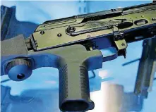  ?? [AP FILE PHOTO] ?? A bump stock devise is attached to a semi-automatic rifle at the Gun Vault store and shooting range in South Jordan, Utah. Bump stocks will be banned under the federal law that prohibits machine guns, effective in late March.