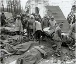  ?? (HMP) ?? ■ Another view of the activity at the Advanced Dressing Station at Feuchy Chapel on 10 April 1917. Here German prisoners are bringing in the wounded. Note the same shelter which can be seen on the left of the main picture below. Note the presence of Reverend Hardy peering over the shoulder of a German prisoner and a British Corporal helping carry the casualty on the stretcher.