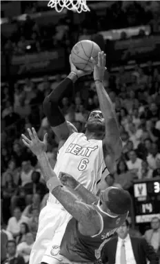  ??  ?? Miami Heat's LeBron James (6) shoots over New York Knicks' J.R. Smith (8) in the first half of an NBA basketball game in Miami.