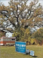  ?? STACEY WESCOTT/CHICAGO TRIBUNE ?? Republican Party signs, including one for Trump and Pence, sit along 176th Avenue in Paris, Wisconsin.