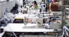  ?? — Reuters ?? An employee sews while working in a factory in the city of Blagoevgra­d, Bulgaria. The IMF said growth in the euro zone was now expected to be slightly stronger in 2018 and pointed to “solid momentum”. It upgraded 2017 GDP growth projection­s for the...