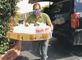  ??  ?? A Belmont mosque run by the Yaseen Foundation prepares items to be delivered to those in need during Ramadan, from top: Muna Zughoul readies a bag of groceries; Mohammed Ali carries restaurant meals; gifts for Eid alFitr include a handwritte­n note.