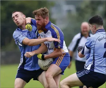  ??  ?? Shillelagh’s Jim O’Brien feels this challenge from Newcastle’s Shane McGee during JAFC in Pearse’s Park, Arklow. Picture: Garry O’Neill