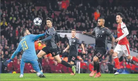  ?? AFP ?? Bayern Munich midfielder Arturo Vidal (second from right) scores their fourth goal past Arsenal goalkeeper David Ospina during their Champions League last16 second leg match at Emirates Stadium in London on Tuesday.