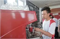  ??  ?? An employee preparing coffee at the Coffee Club.