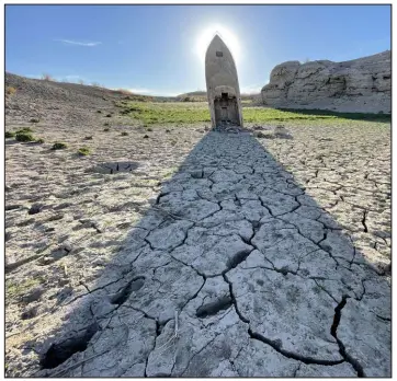  ?? ?? A long-submerged boat, exposed by drought at Lake Mead, stands as a monument to the transformi­ng landscape of Southern Nevada. Photo by Sean Defrank