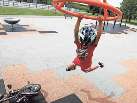  ?? PHOTOS BY BARBARA J. PERENIC/THE COLUMBUS DISPATCH ?? Ebenezer Files, 6, of Columbus, plays on a ring at the newly renovated playground at Dodge Park and Recreation Center on Tuesday.