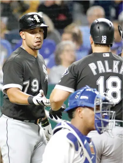  ?? CHARLIE RIEDEL/AP ?? Jose Abreu, who scored on the play, congratula­tes Daniel Palka after Palka’s two-run home run in the third inning.