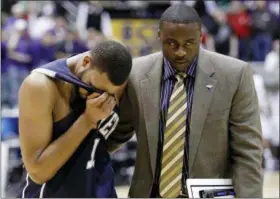  ?? COLIN E. BRALEY — THE ASSOCIATED PRESS FILE ?? In this file photo, Xavier’s Jason Love is consoled by then-assistant coach Orlando Ranson after losing in double-overtime to Kansas State in an NCAA West Regional semifinal college basketball game in Salt Lake City. Maryland has joined the list of...