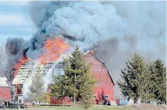  ?? DAVE JOHNSON TORSTAR ?? Flames shoot through the roof of a barn on Dixie Road in Wainfleet Saturday afternoon. Wainfleet Fire and Emergency Services was called for the report of hay bales on fire inside the structure.
