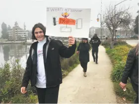  ?? Wendy Lee / The Chronicle ?? Omree Sabo, a student at Berkeley’s Bayhill High School, holds a sign that identifies him as having dyslexia. Students marched to promote inclusion to help students who are socially isolated.