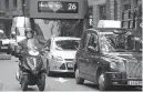  ?? AP Photo/Kirsty Wiggleswor­th ?? n Motorists travel down a street Wednesday in central London. To control air pollution, new diesel and gasoline cars and vans will be banned in the United Kingdom by 2040.