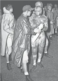  ??  ?? A TD talk is held between Humes coach Rube Boyce and halfback George Blancett. Blancett had just scored Humes' first touchdown on a 33 yard run. Humes went on to whip East High 50 - 0 at Hodges Field on 23 Oct 1951. BOB WILLIAMS/THE COMMERCIAL APPEAL