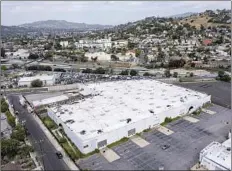  ?? Brian van der Brug Los Angeles Times ?? A DRONE image of industrial warehouses at 141 West Avenue 34 in Lincoln Heights, where developers want to erect the apartments.
