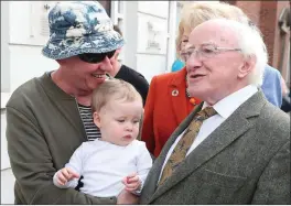  ??  ?? President Higgins met Jim McVeigh and his grandaught­er during a walk around in Drogheda on Sunday.