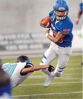  ?? JIM THOMPSON/JOURNAL ?? West Mesa’s Gabriel Ramirez, right, is tripped up by Del Norte’s Isaiah Cowboy in the first half of their game Thursday night at Nusenda Community Stadium.