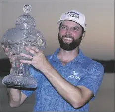 ?? LYNNE SLADKY/AP ?? CHRIS KIRK holds the trophy after winning the Honda Classic golf tournament in a playoff against Eric Cole on Sunday in Palm Beach Gardens, Fla.