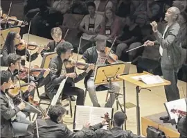  ?? Lawrence K. Ho ?? MAESTRO Thomas Wilkins conducts the young players during a performanc­e Saturday at Walt Disney Concert Hall as part of National Take a Stand Festival.