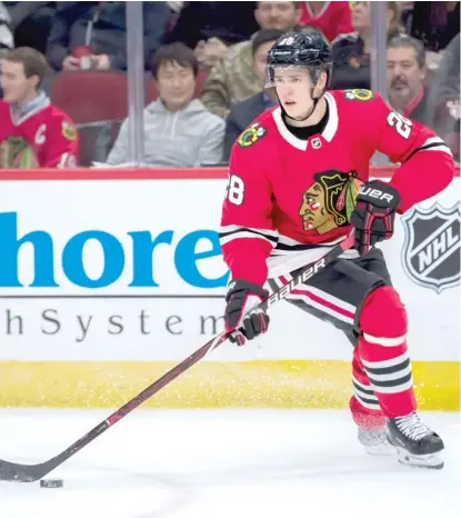  ?? PATRICK GORSKI/AP ?? Blackhawks coach Joel Quennevill­e likes the way defenseman Henri Jokiharju participat­es in the attack.