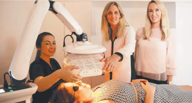  ?? Picture: JUSTIN BRIERTY ?? BEST LOOK: Laser therapist Monique Sorbello prepares a treatment for Vesna Crumblin as franchise co-owners Angela and Linda Rogan look on. ALICIA NALLY