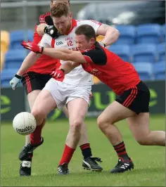  ??  ?? Tinahely’s Stephen Dillon gets his shot away despite the attention of Coolkenno’s Willie Doyle.