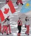  ?? PAUL CHIASSON THE CANADIAN PRESS ?? Short-track speedskate­r Kim Boutin leads Team Canada into the Olympic stadium for the closing ceremonies.
