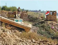  ?? AP ?? Iraqi soldiers along the border with Syria, in Qaim. Life in Qaim has been put on hold as just across the border fighting rages against one of the last major Daesh enclaves.