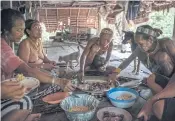  ??  ?? IN THE FAMILY: Mentawai tribe members gather around for dinner on Siberut Island.