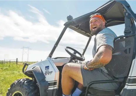  ?? Photos by Michael Ciaglo, Special to The Denver Post ?? Broncos offensive linemen Dalton Risner cheers as he watches some of his fellow rookies play during his family’s annual golf scramble tournament that took place Saturday on the Risner family farm in Wiggins.